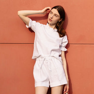 White linen shorts with pockets and folded hem