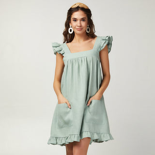 Short light green linen sundress with ruffles