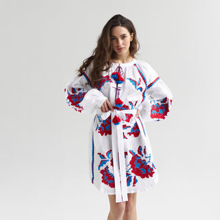 White linen dress with bright floral embroidery