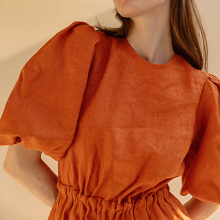 Orange linen summer midi dress with puffed sleeves and open back