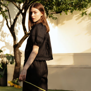 Black linen top with puffed sleeves and open back