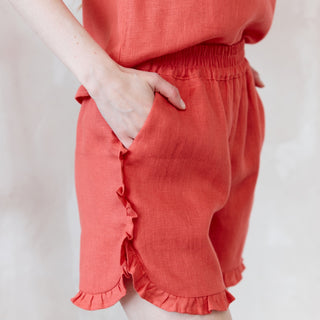 Coral linen shorts with side pockets and frill details