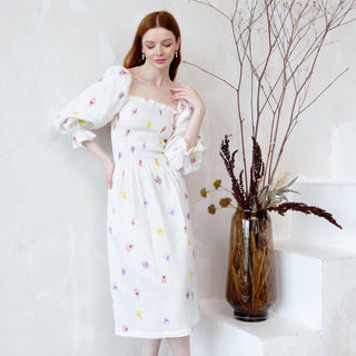 White linen midi dress with floral print and lush sleeves