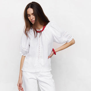 White linen shirt with lace details and puffed sleeves