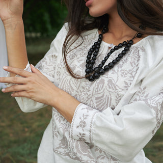 Embroidered details of white linen shirt