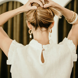 Frilled details of white linen top